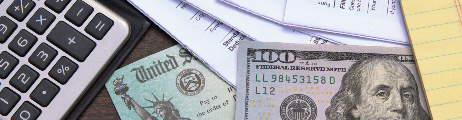 Money, IRS Form 1040, and a calculator representing financial risks of ERC claims through PEOs.