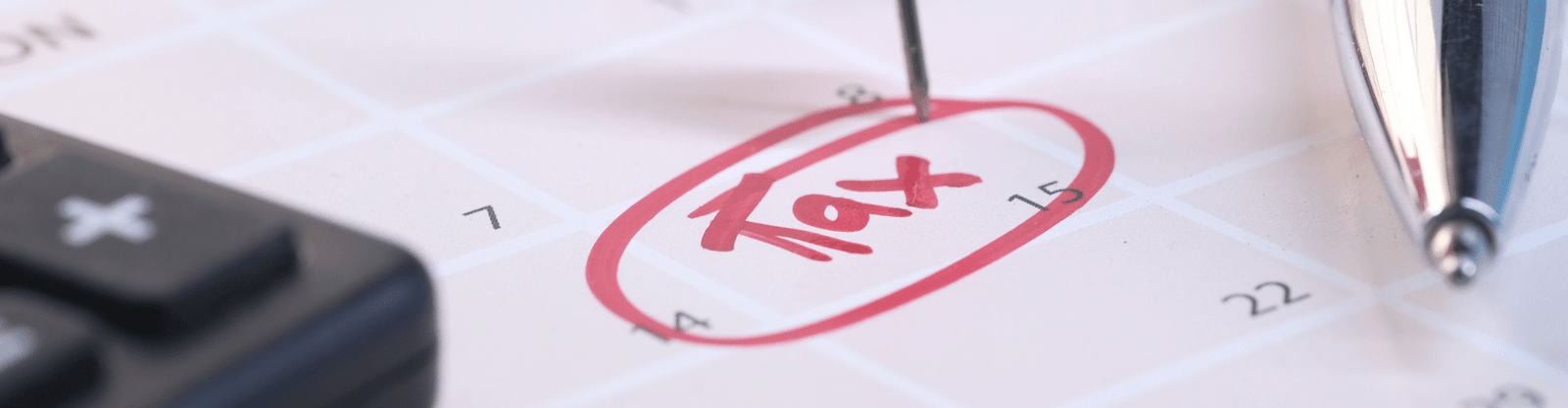 Close-up of a calendar with the word 'Tax' circled in red ink, marked with a pin, symbolizing a critical tax deadline or planning date.